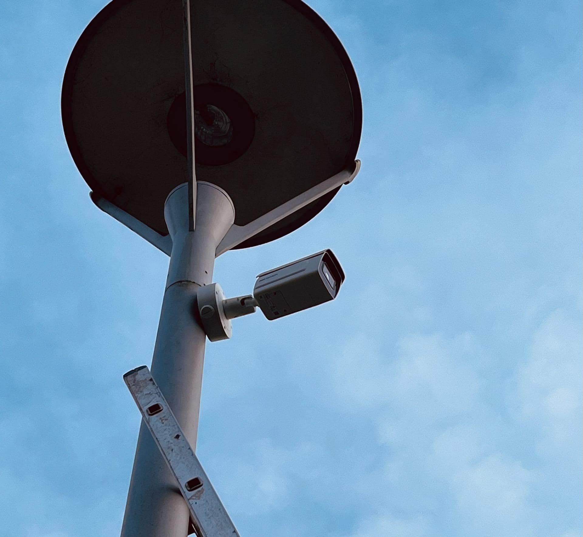 Close-up of a bullet CCTV camera mounted on a lamp post