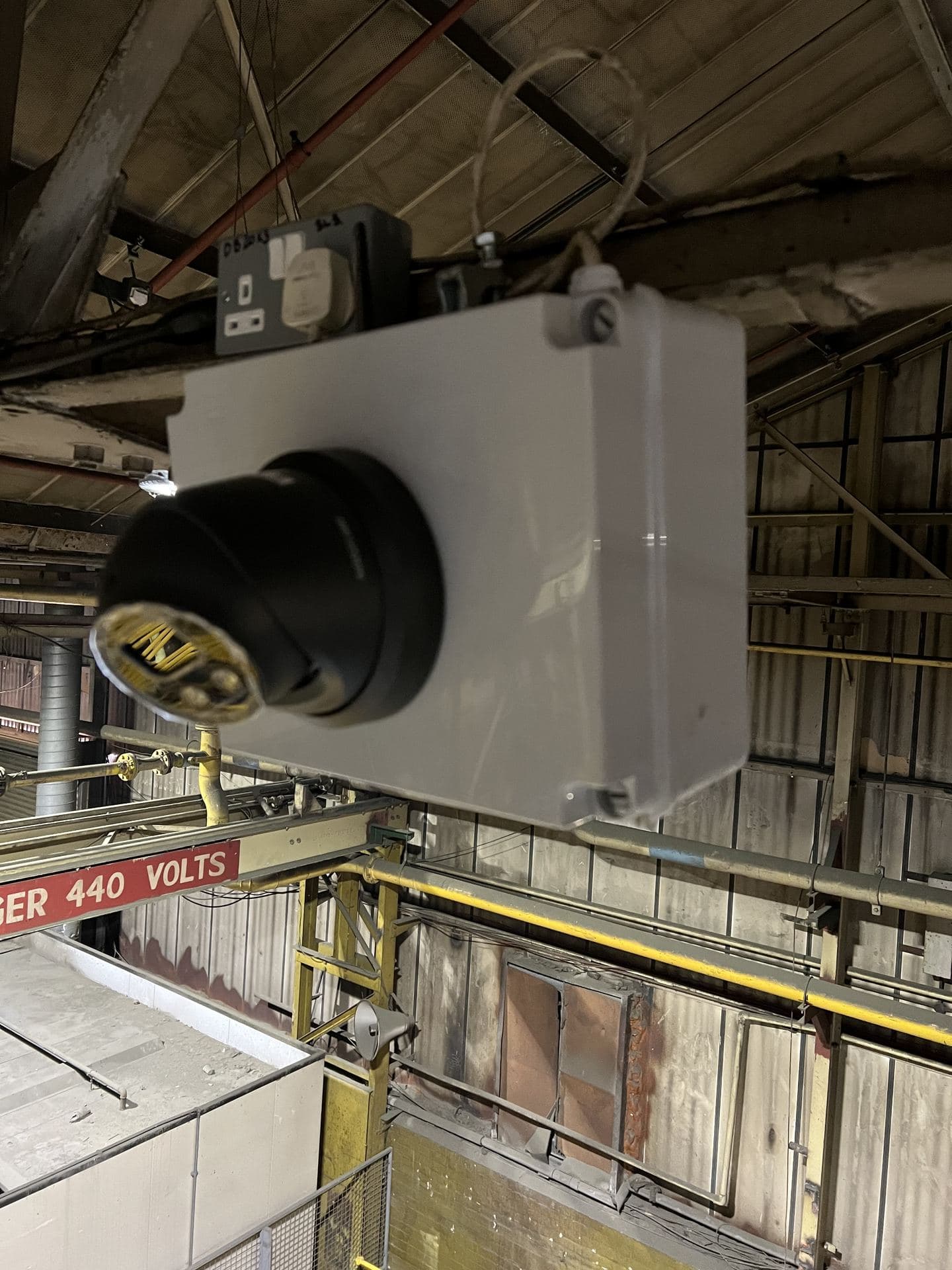 Dome CCTV camera mounted in a warehouse roof void